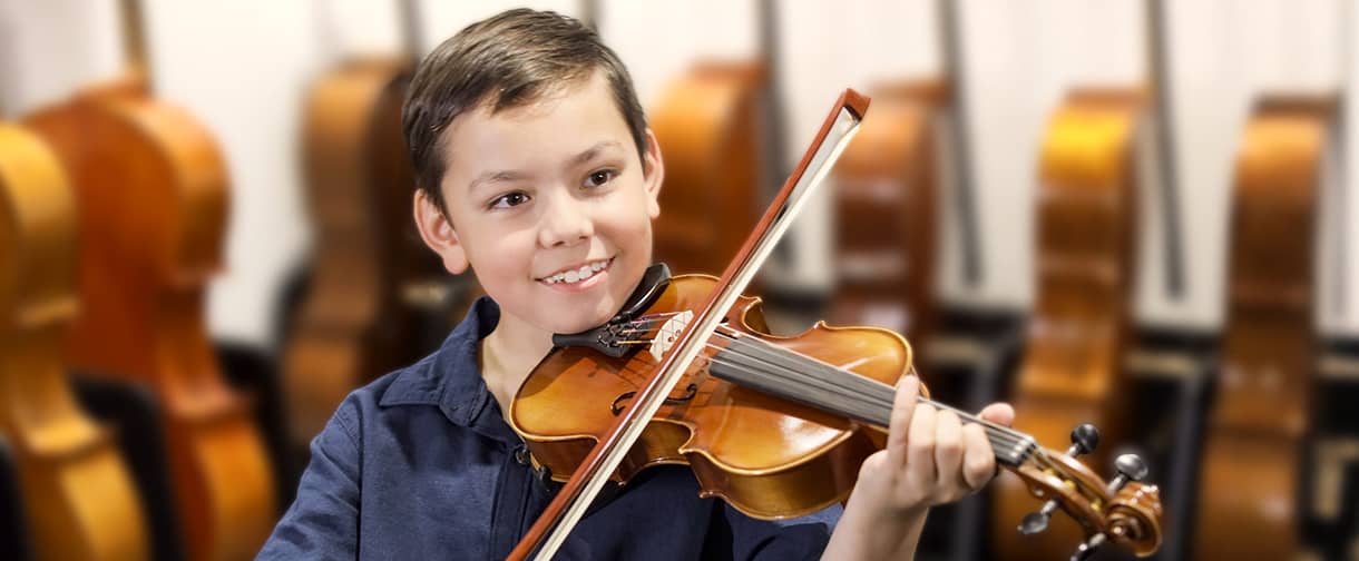 A boy playing viola.